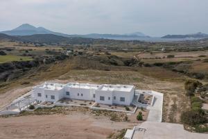 an aerial view of a white house on a hill at Sunset Village 5 in Paleochori +7 photos