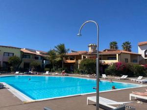 una piscina in un resort con persone di Porto Antigo - Charming & peaceful apartment overlooking pool and sea a Santa Maria