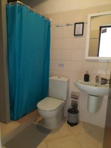 a bathroom with a toilet and a sink at Solstice in Santa Maria