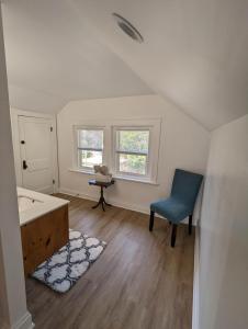 a bathroom with a tub and a chair in a room at Downtown Retreat - 1BR Oasis with Parking in Columbus