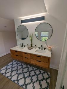 a bathroom with a sink and a mirror and a rug at Downtown Retreat - 1BR Oasis with Parking in Columbus