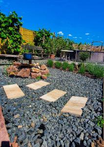 a stone walkway in a garden with a chair at Casamia4u in Alsóörs