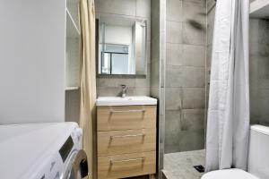 a small bathroom with a sink and a shower at Les Ebihens - Studio et chambre indépendante in Saint-Cast-le-Guildo +10 photos
