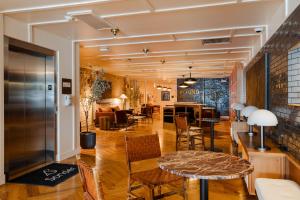 a lobby with a table and chairs and a bar at Found Chicago powered by Sonder in Chicago