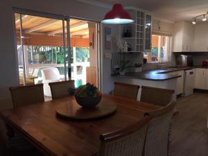 a kitchen with a wooden table with a bowl of fruit on it at 35 on Grand Bahama in Cape Town