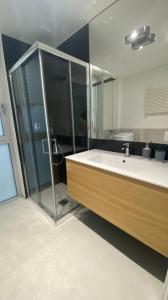 a bathroom with a shower and a tub and a sink at Casa d'aMare Polignano a mare in Polignano a Mare +24 photos