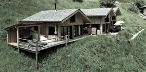 a house sitting on top of a hill at Chalet Tschogerhof Tiers am Rosengarten Dolomiten in Tires