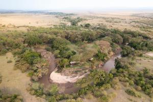 an aerial view of a river and trees at Basecamp Adventure in Masai Mara