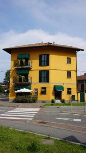 a yellow building on the side of a street at HOTEL DEL CORSO in Borgomanero