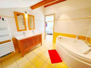 a bathroom with a white tub and a sink at Magnifique duplex de 130 m² à Corte (centre ville) in Corte
