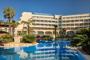 a hotel with a swimming pool in front of a building at Golden Bahía de Tossa & Spa 4* Sup. in Tossa de Mar