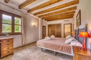 a bedroom with a bed and a desk and windows at Ideal Property Mallorca - Sa Pleta in Petra
