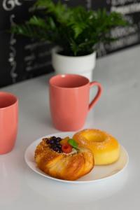 a plate with a pastry and a cup of coffee at Sweet Underground Studio close to PGE Narodowy by Renters in Warsaw