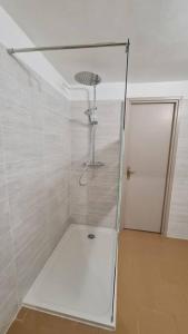 a shower with a glass door in a bathroom at Gîte Le Lion d'Or in Brignoles