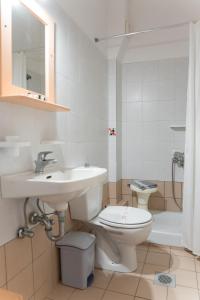 a bathroom with a sink and a toilet and a shower at Ammousa Hotel Apartments in Lixouri