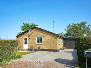 a brick house with a garage and a driveway at Holiday home Rønne VI in Rønne