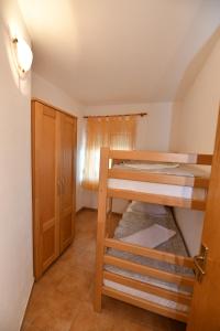 a room with two bunk beds and a cabinet at Apartmani Ajduković in Sevid
