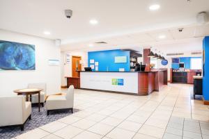 a lobby of a hospital with chairs and a counter at Holiday Inn Express Shrewsbury, an IHG Hotel in Shrewsbury