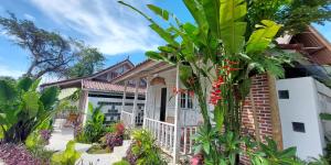 a house withtropical plants in front of it at Spaces Bali in Dalung