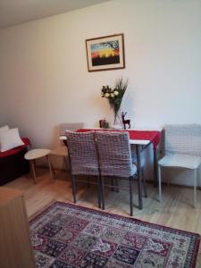 a dining room with a red table and chairs at APARTMAN MILICA in Požarevac