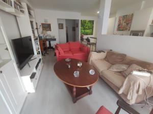 a living room with a couch and a table at Nice room-Terrace- Private toilete-Closer Sport Pier-Optical Fiber 1 GB in Las Palmas de Gran Canaria