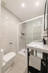 a bathroom with a shower and a toilet and a sink at Indulge en Sevilla Cuna in Seville
