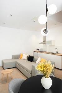 a living room with a couch and a table at Blanq Marina Suites in Valencia