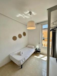 En eller flere senge i et værelse på Ruzafa Vibes Apartments