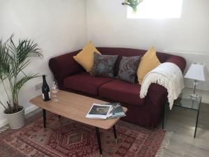 a living room with a couch and a coffee table at Brighton Boutique Garden Studio with Free Parking in Brighton & Hove