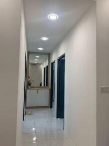 a hallway of a room with white walls and a mirror at Kita Impian Residence @ Cybersouth in Kampung Dengkil