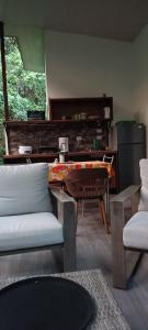 a living room with a couch and a piano at Selva Linda Lodge vacation rentals in Quepos