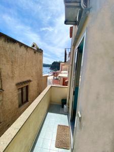 a balcony of a building with a view of the ocean at "La Terrazza" Corricella in Procida