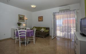 a living room with a table and a couch at Apartments Plazibat in Hvar