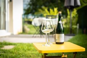 a bottle of wine and a glass on a table at Leptitchezsoi, calme et cosy à 5 mn du centre de Bayeux in Vaucelles