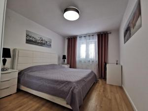 a bedroom with a large bed and a window at Villa Lamanova in Rovinj