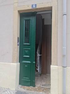 a green door in the side of a building at S.Soares Beato 6.3E in Lisbon