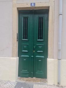 a green door on the side of a building at S.Soares Beato 6.3E in Lisbon