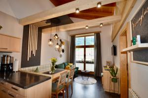 a kitchen and living room with a table and chairs at Apart Marie-Therese in Umhausen