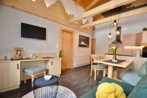 a living room and kitchen with a couch and a table at Apart Marie-Therese in Umhausen