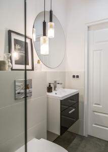 a bathroom with a sink and a mirror at Old Town Heart X Luxury - Piekna in Warsaw