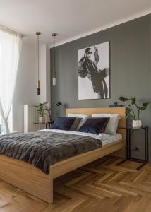 a bedroom with a bed with a wooden bed frame at Old Town Heart X Luxury - Piekna in Warsaw