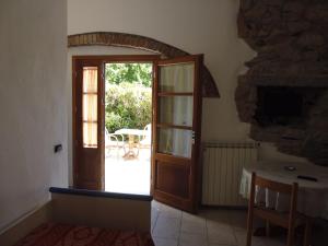 an open door to a patio with a table at Villa il Poderino in Marina di Campo