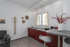 a kitchen with white walls and a counter and a table at Sunset Village 3 in Paleochori