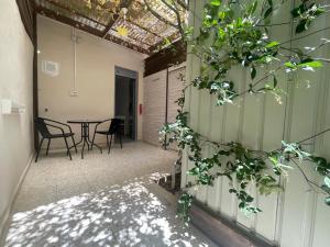 a courtyard with a table and chairs in a building at PassionFruit Arad in Arad