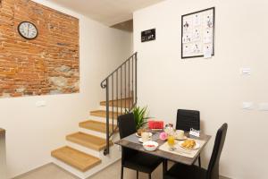 a dining room with a table and a staircase at The Bricks B&B Free Parking in Pisa