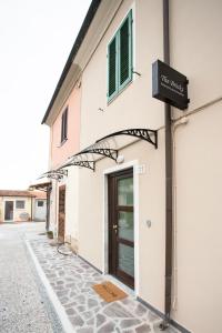 a building with a sign on the side of it at The Bricks B&B Free Parking in Pisa