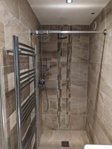 a shower with a glass door in a bathroom at Home in Alwoodley, Leeds