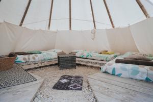 a room with four beds in a tent at Tipi / Nature / Détente in Bragny-sur-Saône