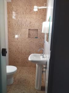 a bathroom with a sink and a toilet at Hostel Bimba Goiânia - Unidade 01 in Goiânia