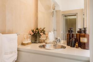 a bathroom counter with a sink and a mirror at Villa with private pool and garden by Go2oporto in Terroso